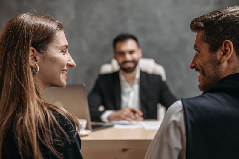 Two clients meeting with a lawyer in an office